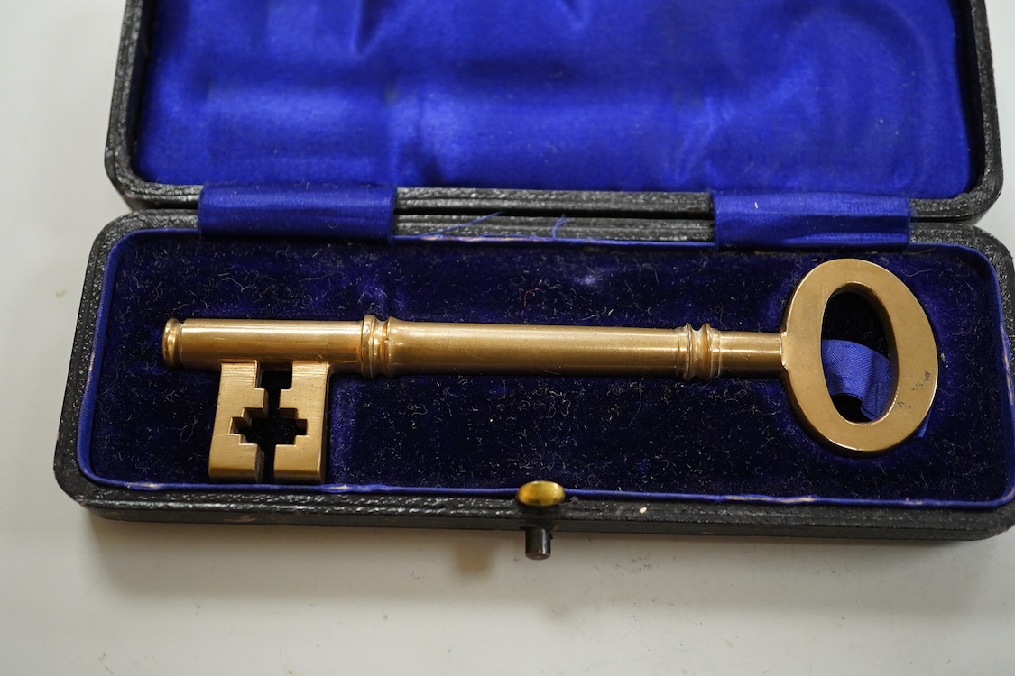 A collection of sundry items to include a large cased key, novelty lighter in the form of a shoe and a citrine set propelling pencil